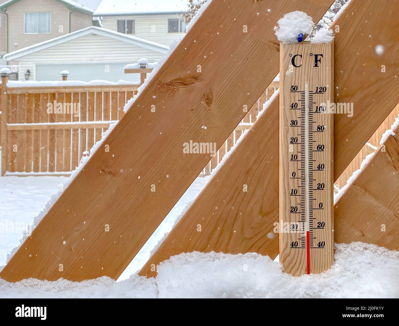 A Thermometer on a snow fall with a cold temperature. Stock Photo
