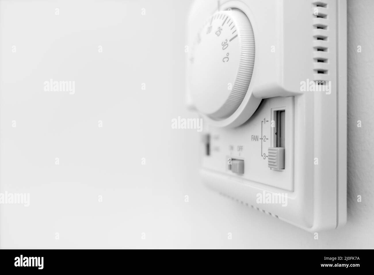 Hand adjusting thermostat Stock Photo Alamy