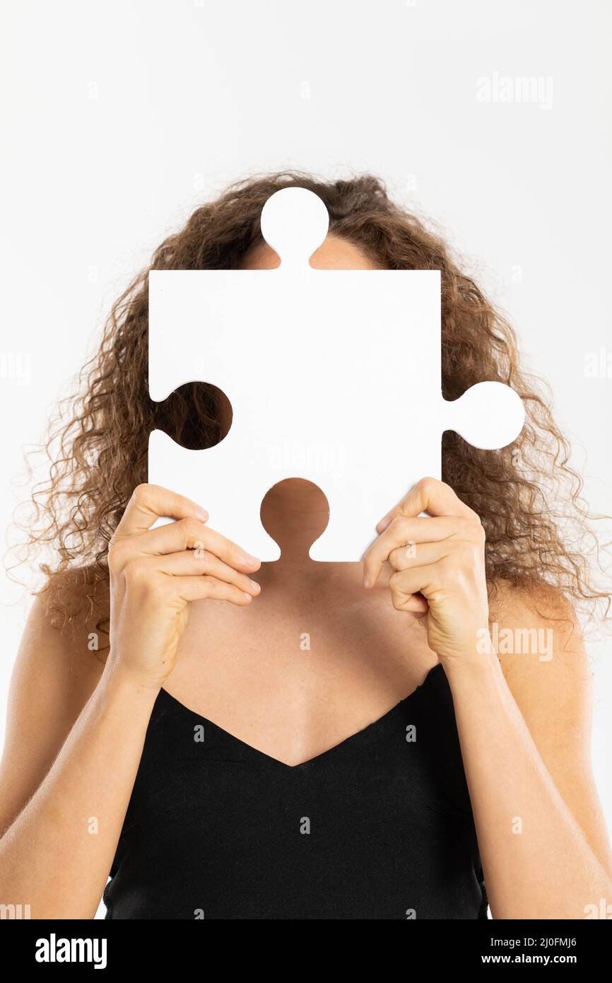 Maintained anonymity by covering your face with one large puzzle. Let's include race tolerance. Stock Photo