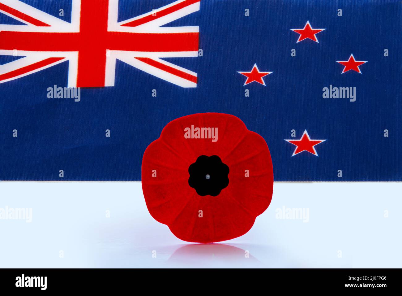 A remembrance day poppy flower with a Australian Flag on the background. Stock Photo