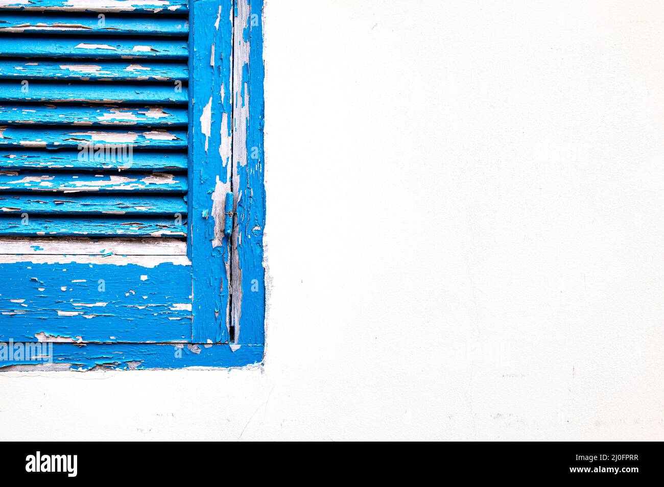 Blue wooden closed window on a white wall Stock Photo