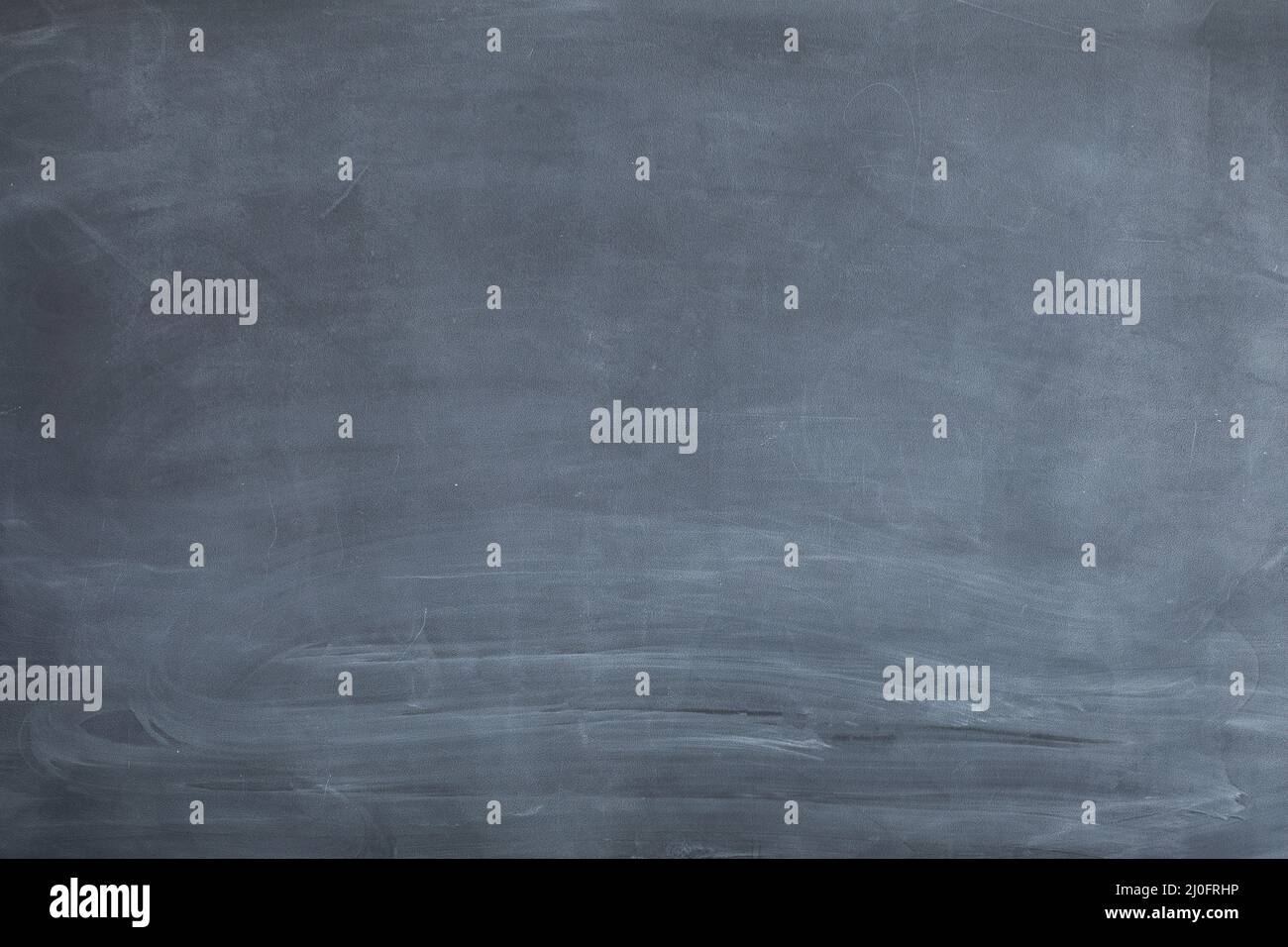 Chalkboard not well sponged. The simplest arithmetic problem in mathematics - adding two numbers together. Stock Photo