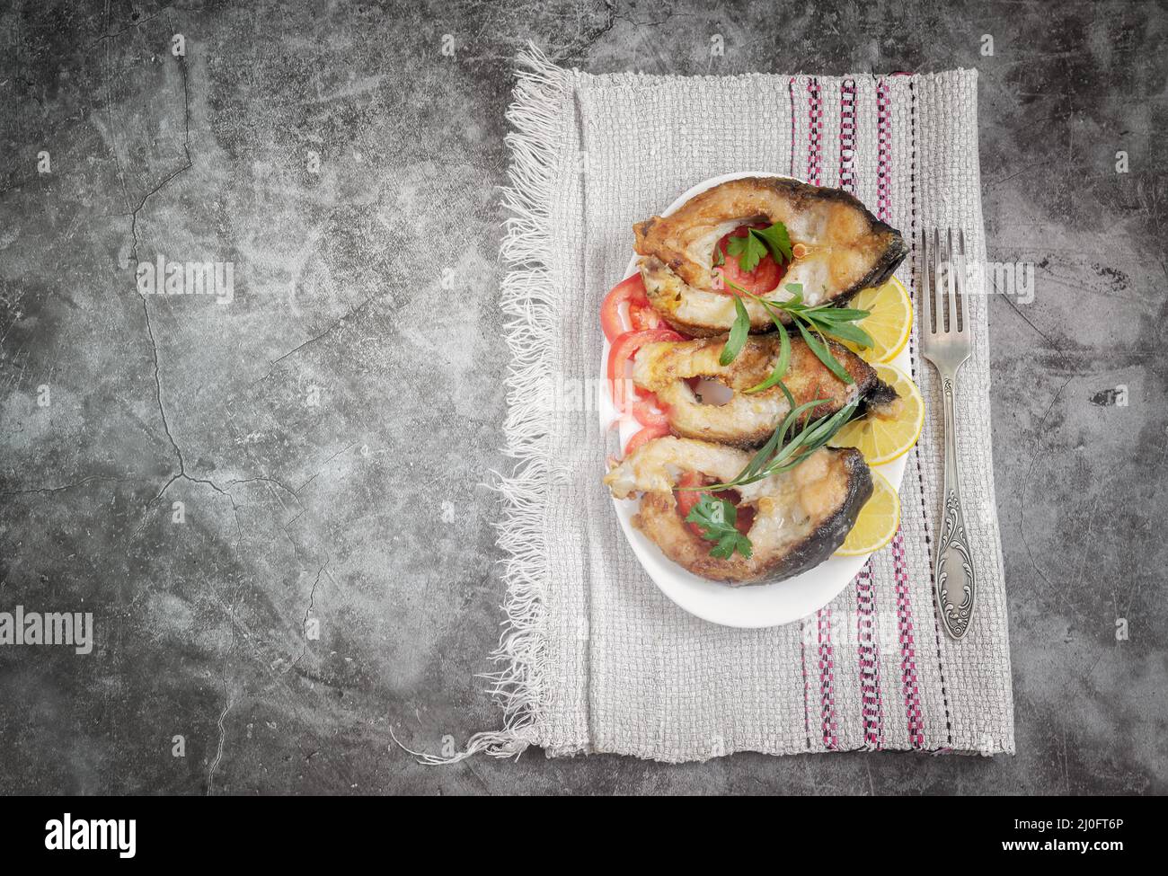 Fried fish carp on the table on a plate Stock Photo Alamy