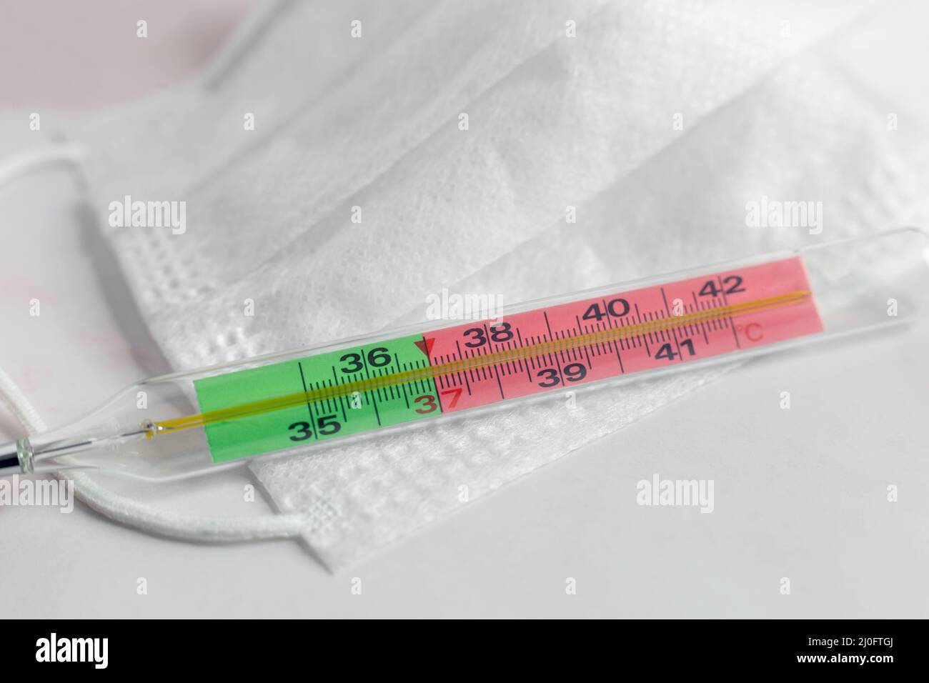 The thermometer shows an elevated temperature for a coronavirus infection Stock Photo