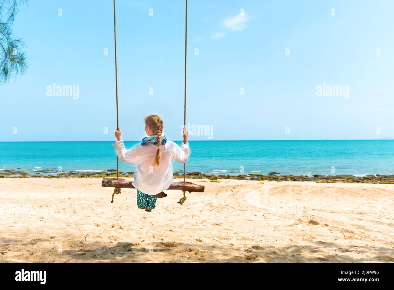 Woman on beach swing Stock Photo Alamy