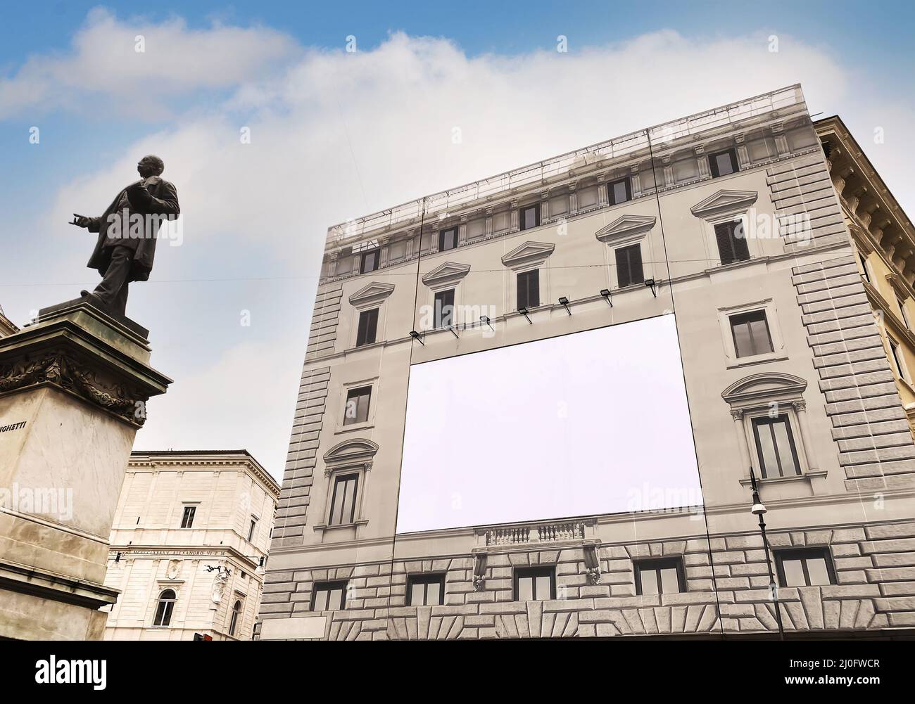 Blank advertising billboard on the scaffolding of the facade of an ancient building under restoratio Stock Photo