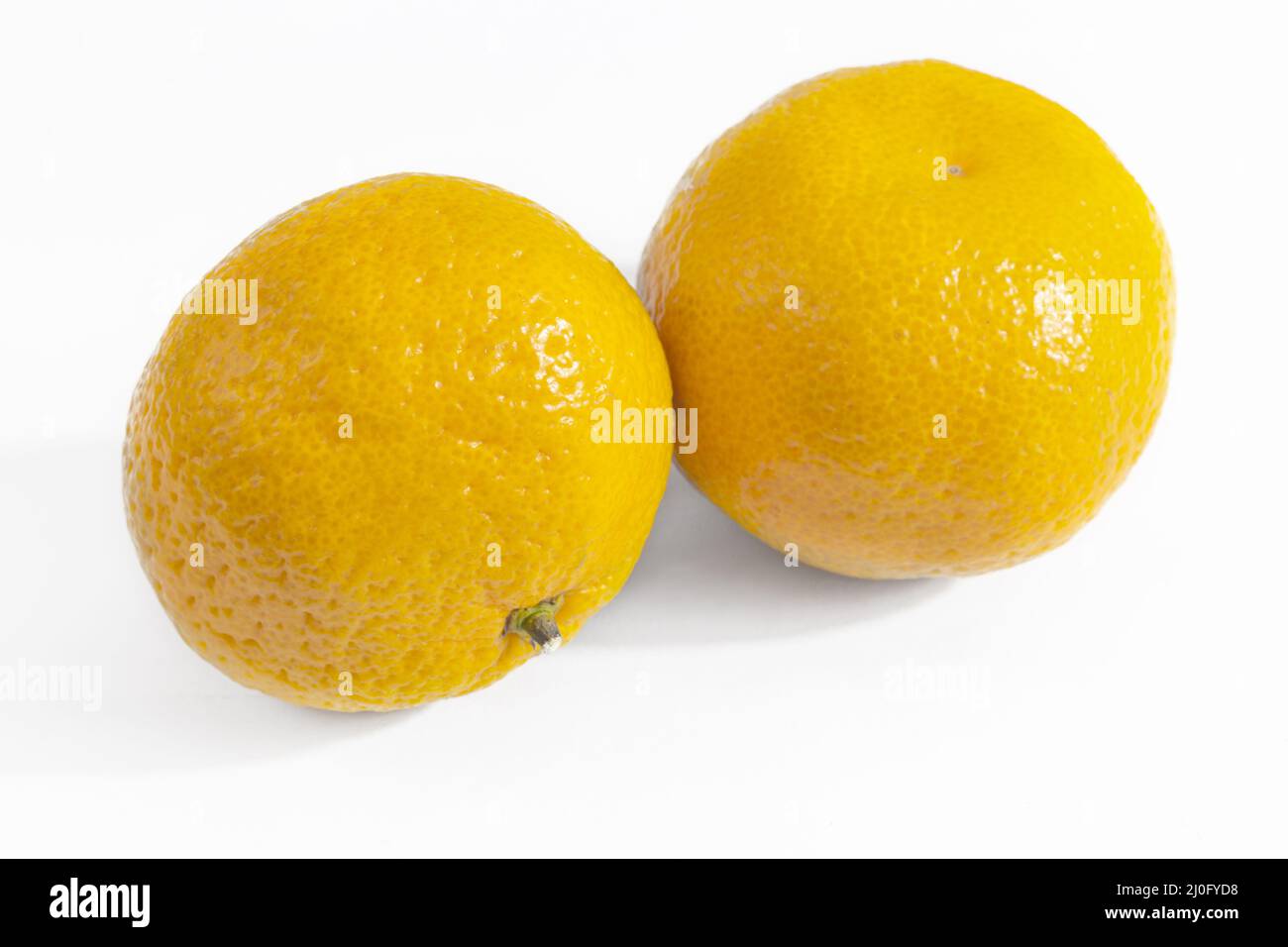 Two ripe tangerines on a white background Stock Photo
