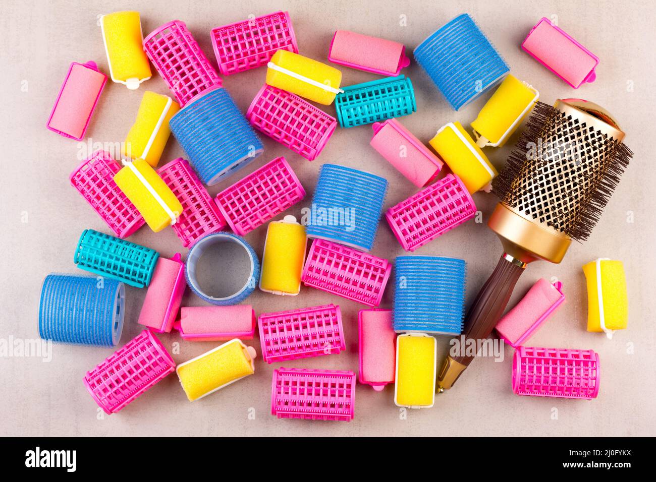 Hair curlers of different colors and the comb top view closeup Stock Photo