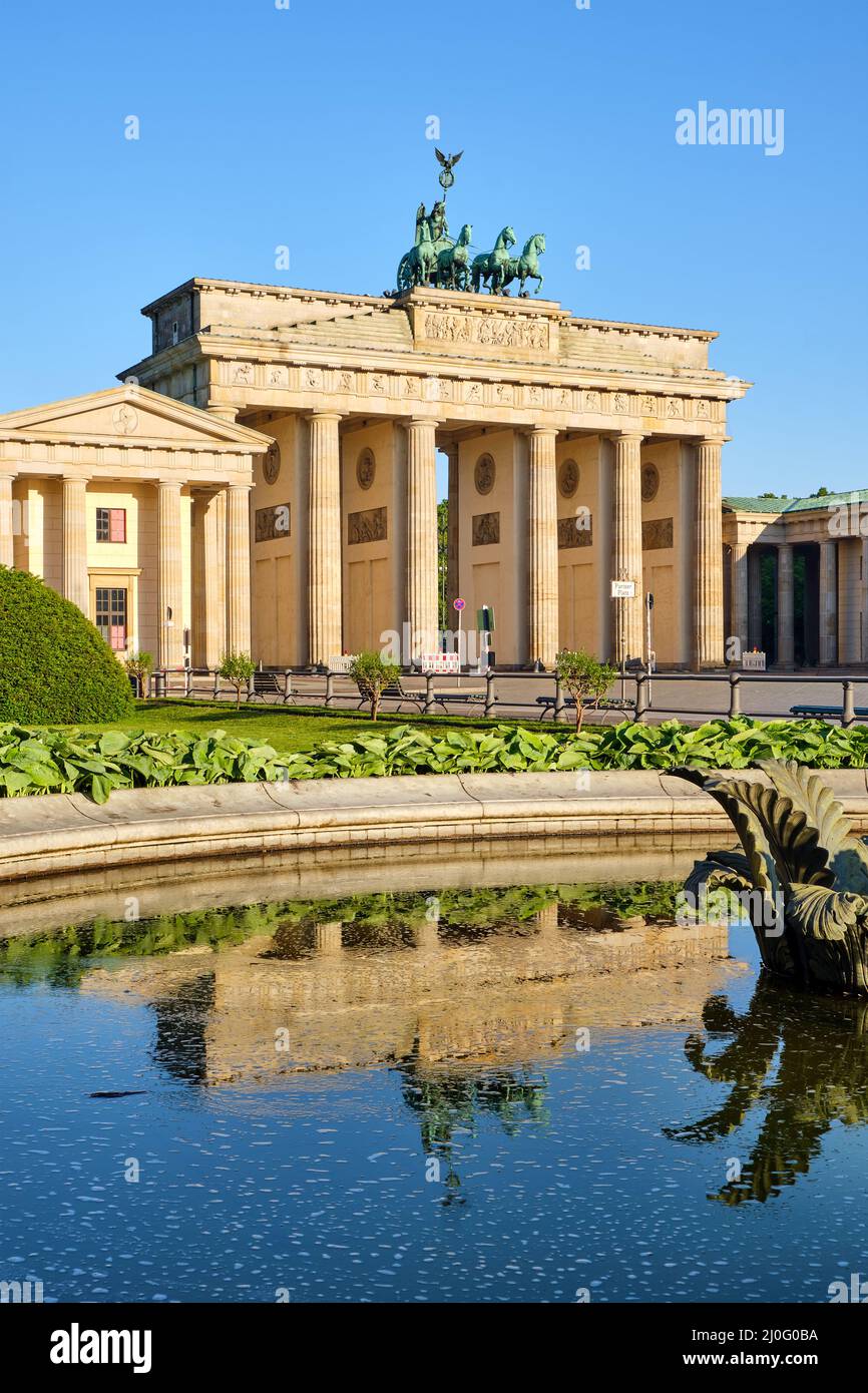 The famous Brandenburg Gate in Berlin with a small pond Stock Photo