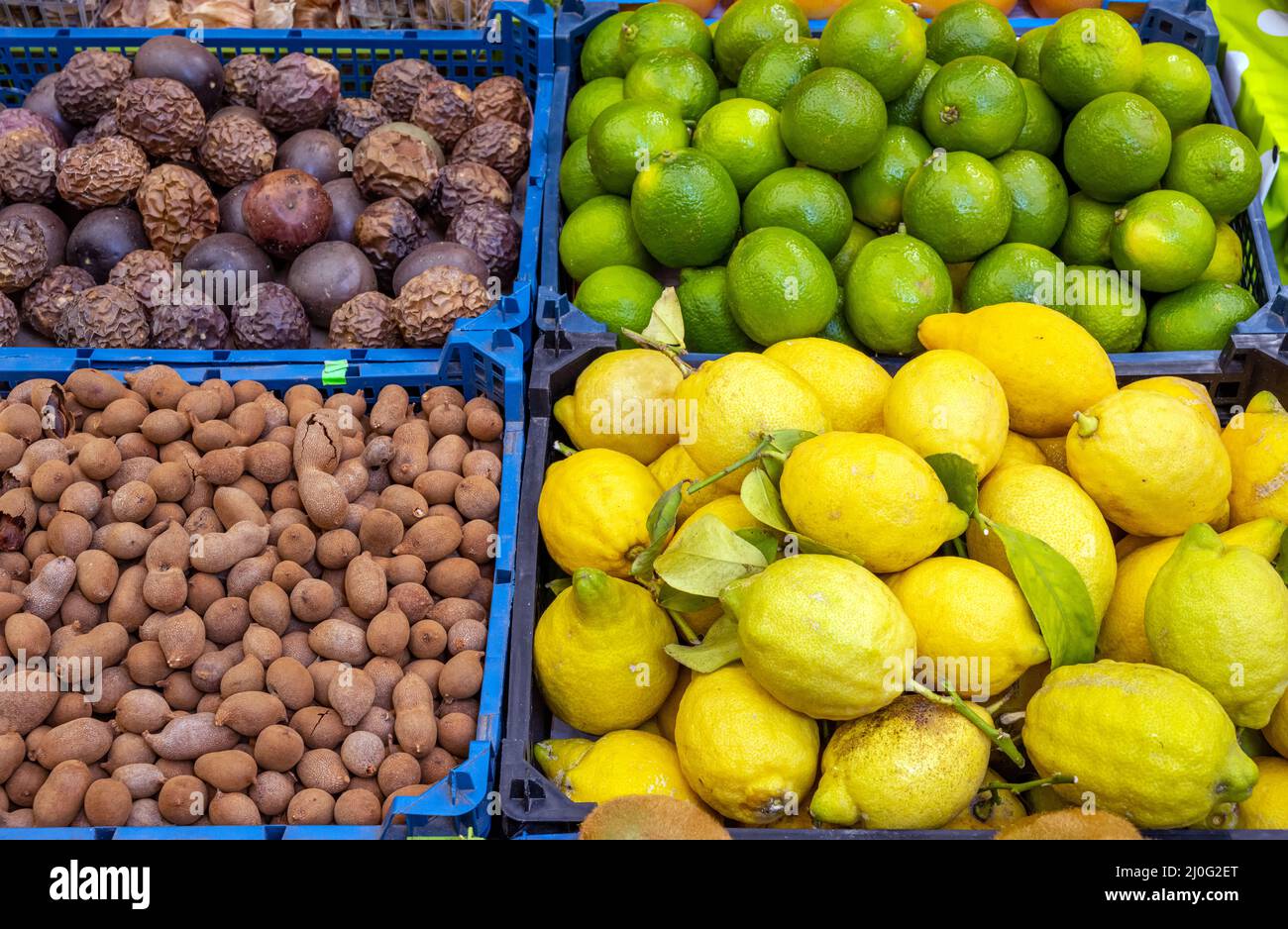 Passion fruits, tamarinds and lemons for sale at a market Stock Photo