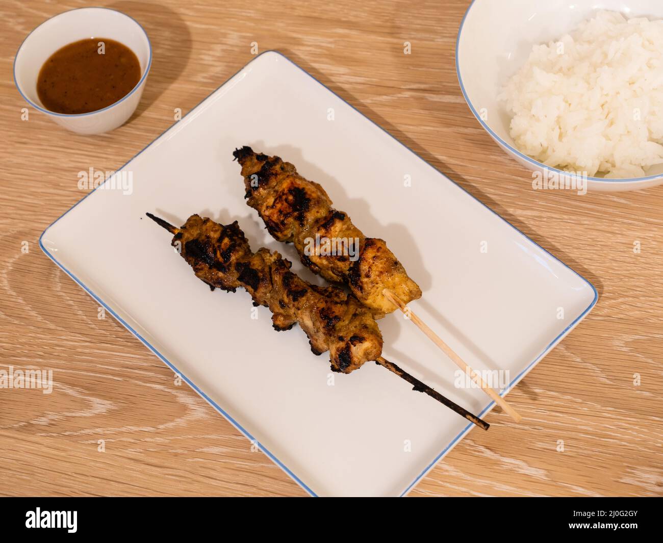 Grilled Chicken Satay BBQ Skewer or Sate ayam with Rice and Peanut Sauce Stock Photo