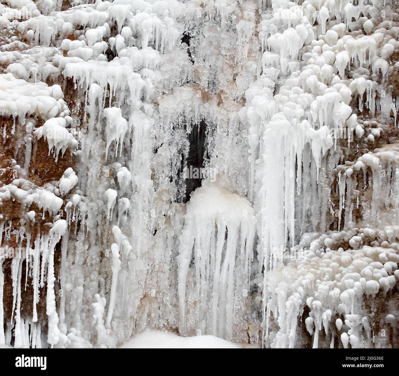 River frozen waterfall with icicles. The winter landscape. Winter background. Square photo Stock Photo