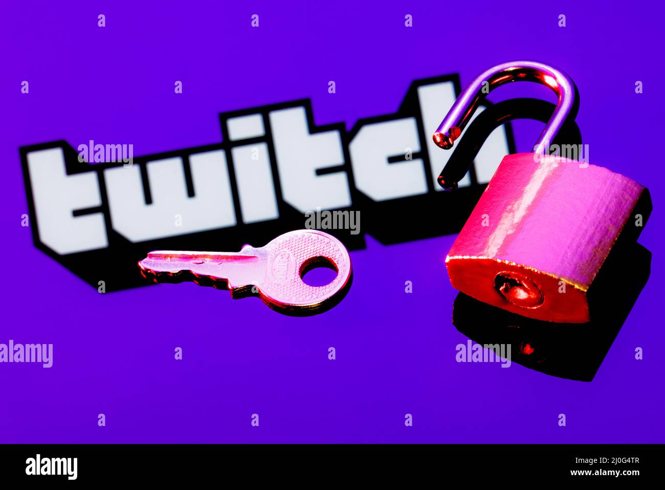 An Open Security Lock And Key On The Background Of The Twitch Live Streaming Service Logo In The Mirror Reflection Stock Photo Alamy