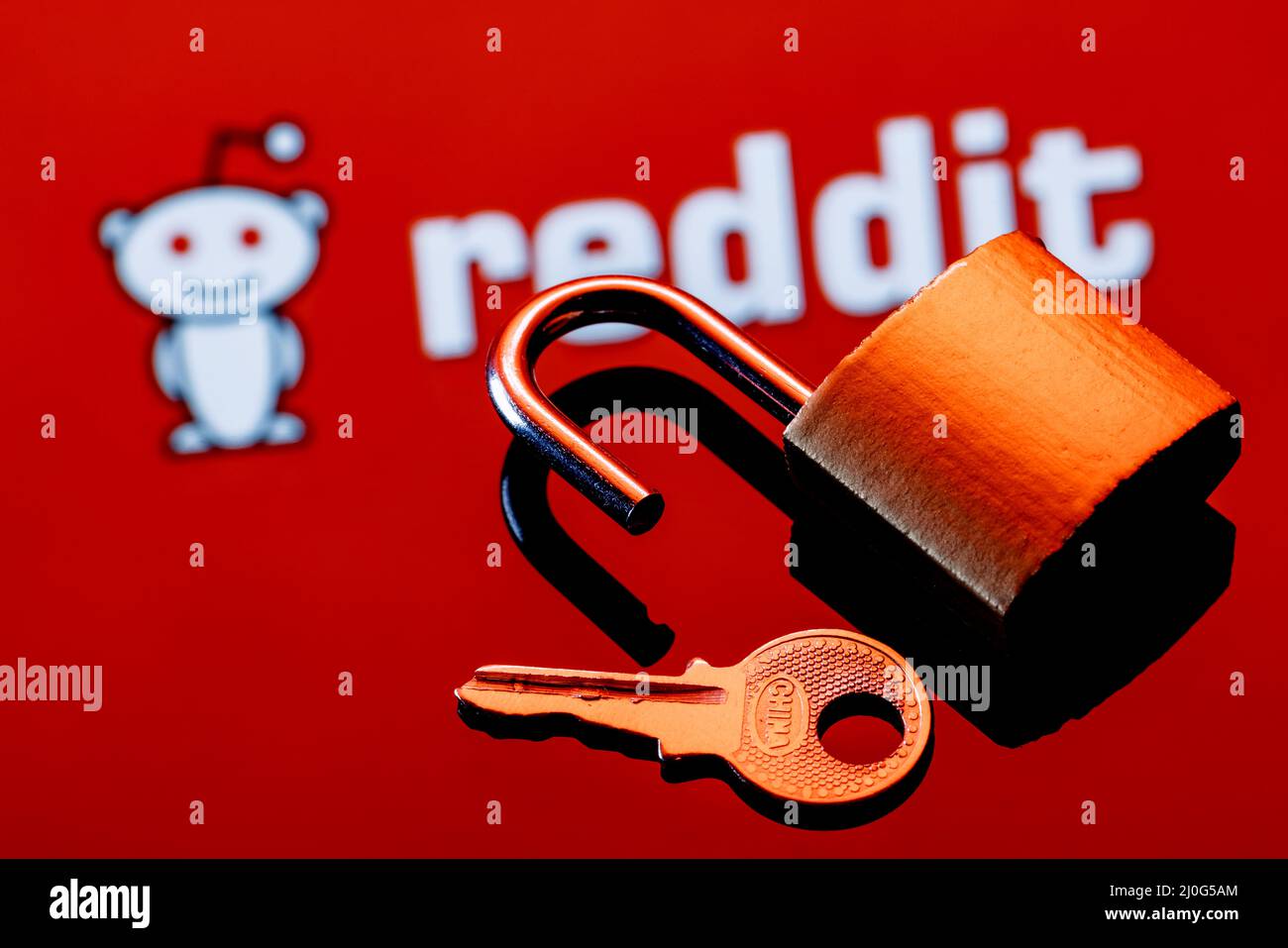 An open security lock and key on the background of the Reddit