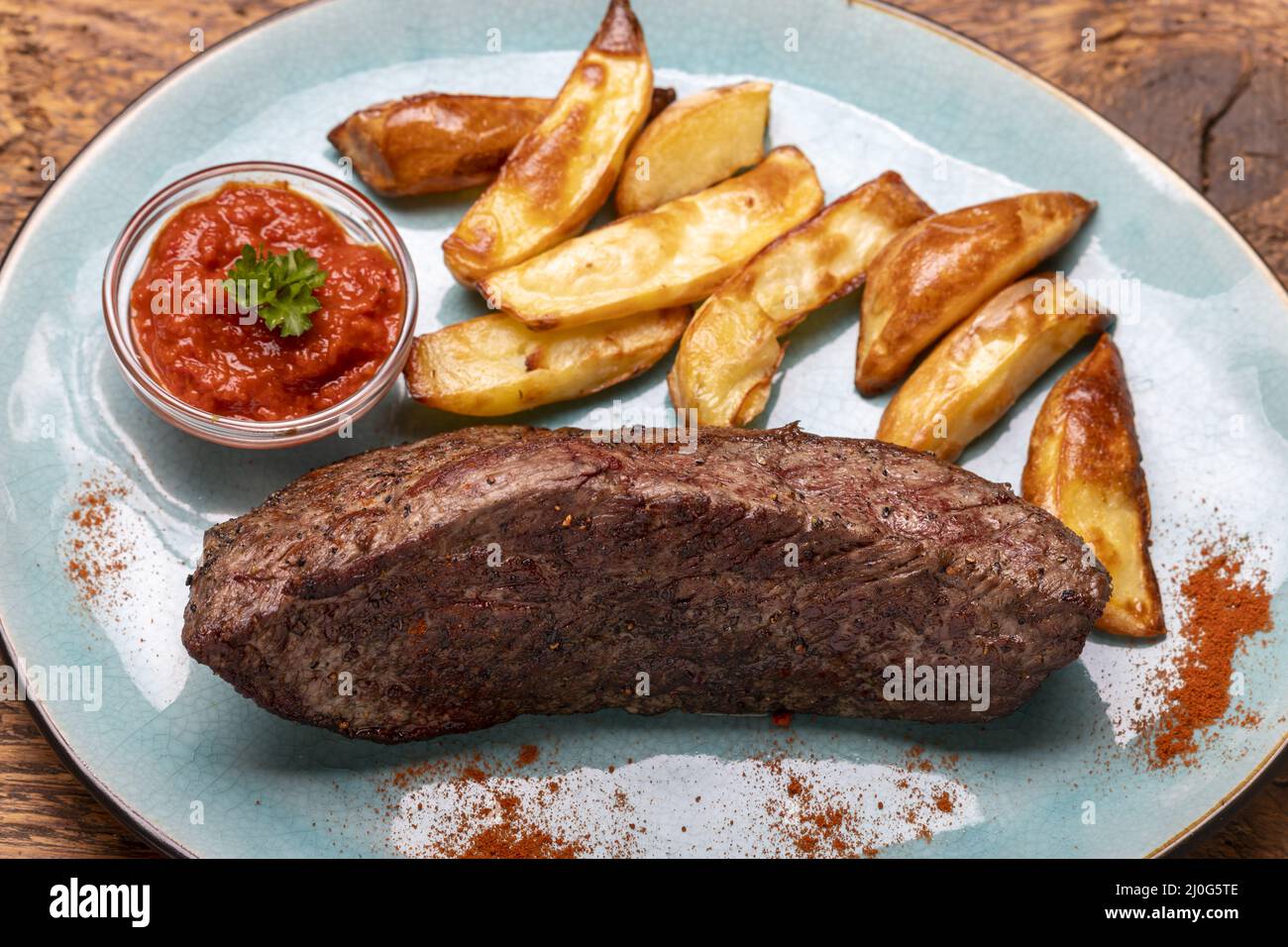 Grilled steak with chips on wood Stock Photo Alamy