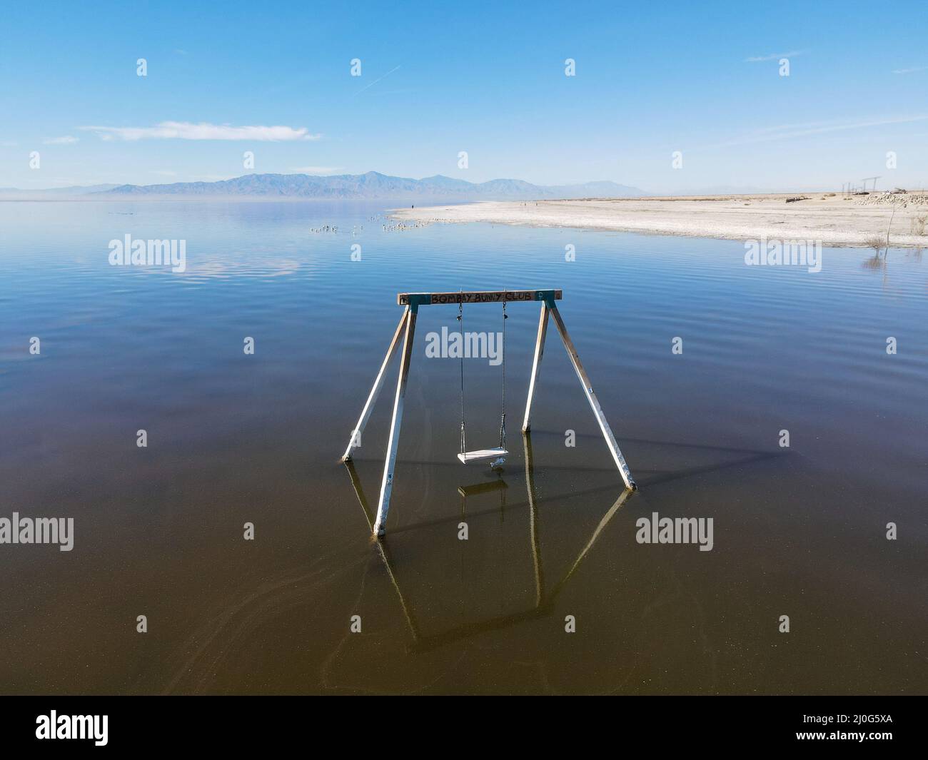 Abandoned swing in the water at Bombay beach, Salton Sea, California Stock Photo