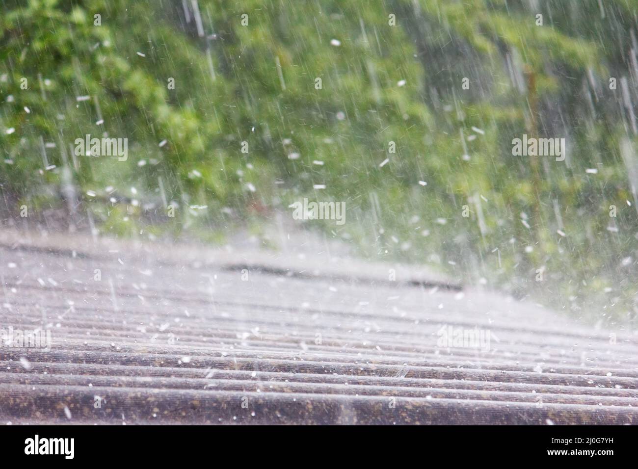 Summer rain with hail falls on the roof of slate Stock Photo