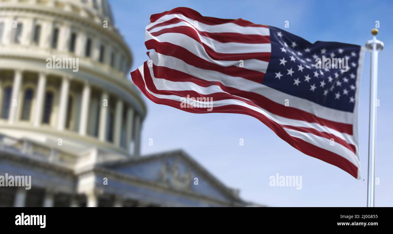 American flag waving with the US Capitol Hill Stock Photo - Alamy