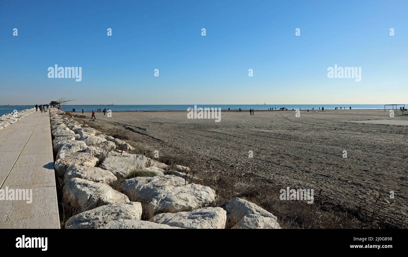 long dam of stones and concrete in the town of Sottomarina near the island of Venice in northern Italy Stock Photo