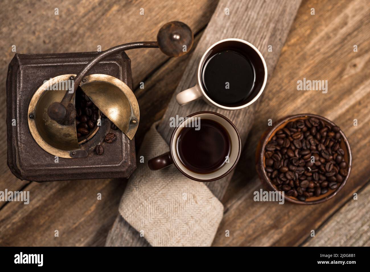 Coffee and coffee beans on old rustic wood table Stock Photo - Alamy
