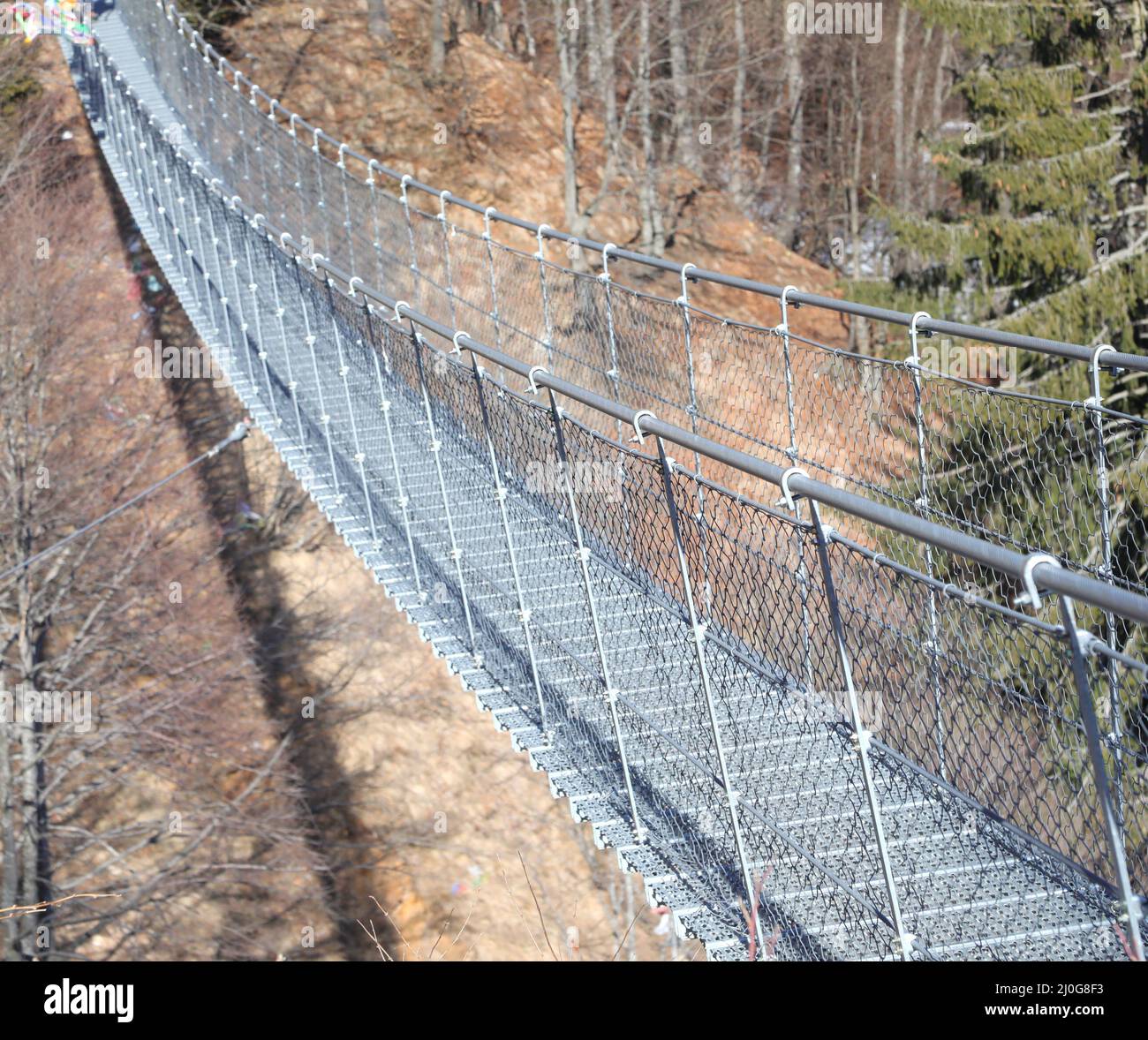 long suspension bridge called Tibetan bridge made with sturdy steel cables to connect the two mountain ridges Stock Photo