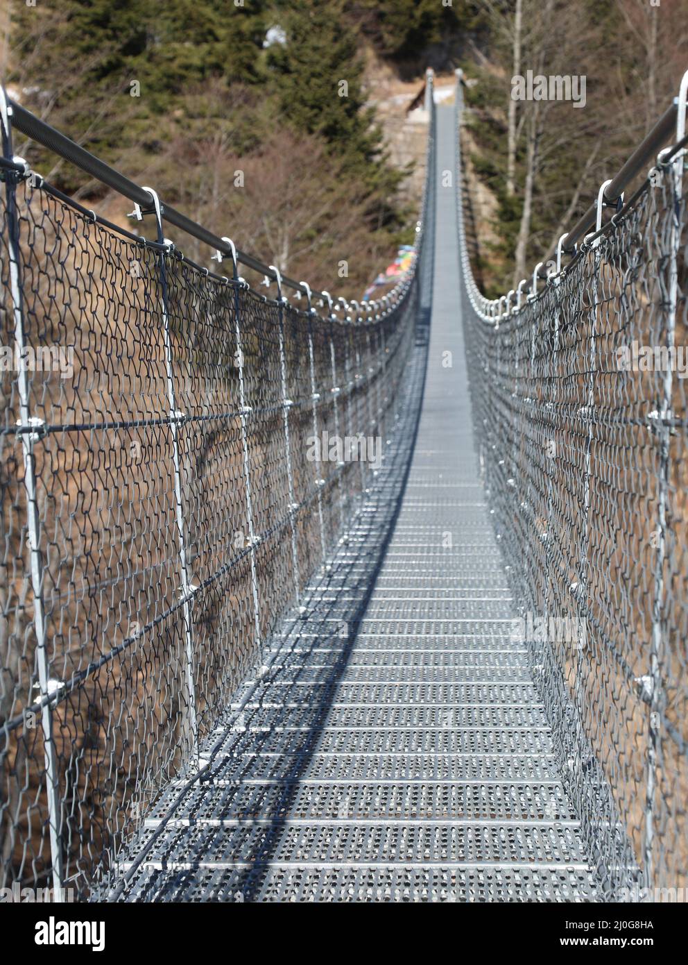 very long  suspension bridge in stainless steel without people in winter near Vicenza town in Italy Stock Photo