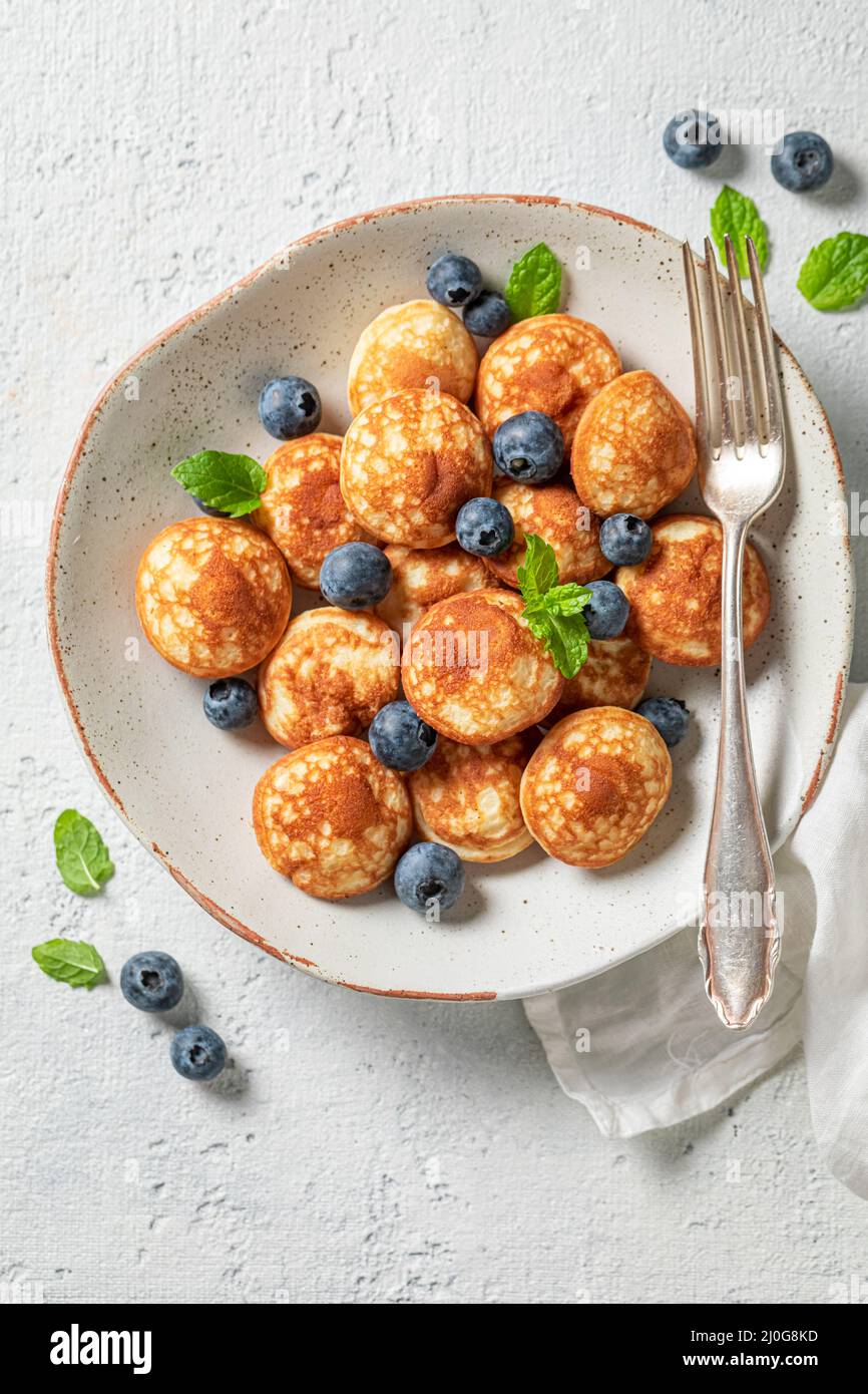 https://c8.alamy.com/comp/2J0G8KD/tasty-poffertjes-for-fresh-breakfast-breakfast-with-mini-pancakes-and-berries-2J0G8KD.jpg