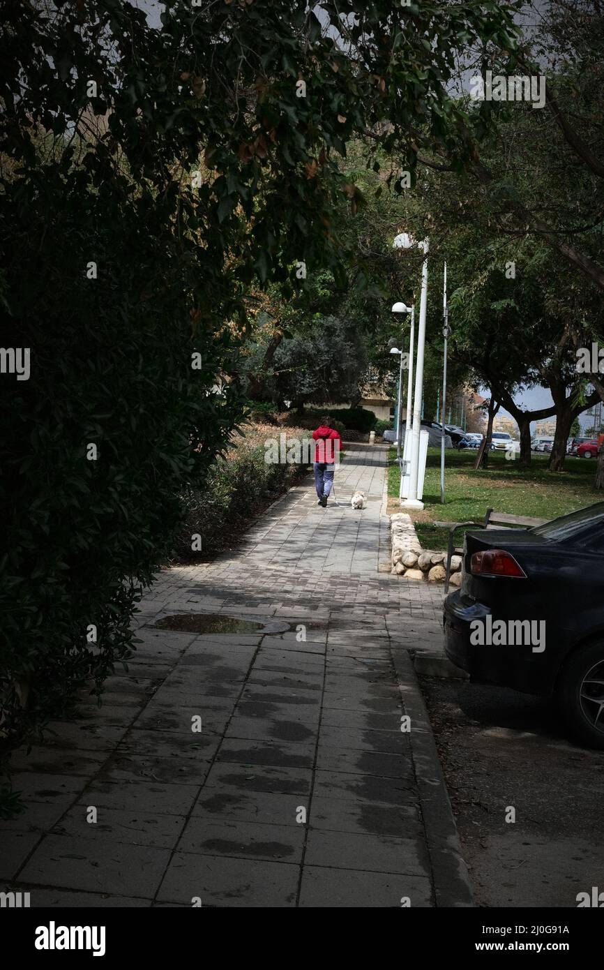 Woman walking on the sidewalk hi-res stock photography and images - Alamy