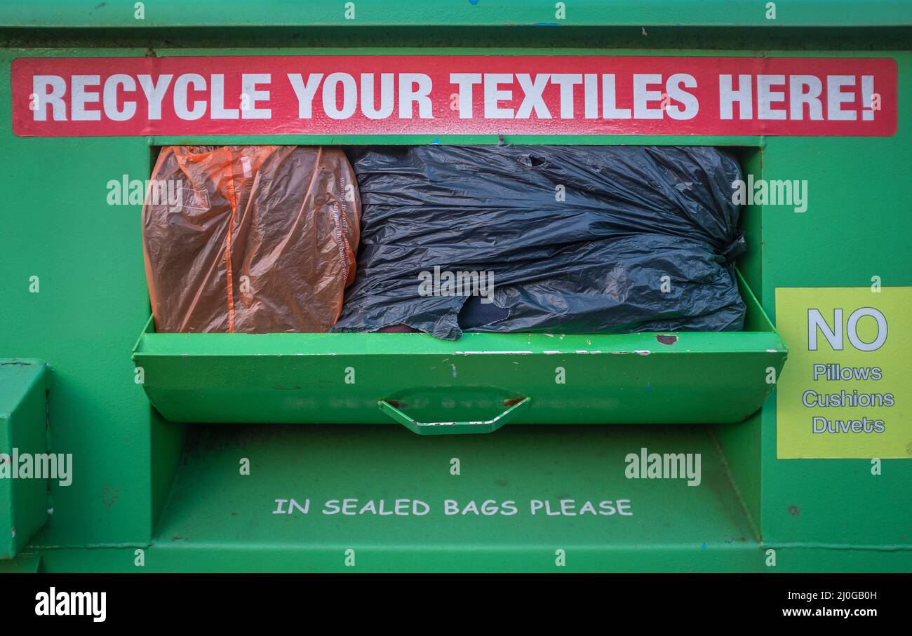 Overflowing Textile Recycling Bin Stock Photo Alamy