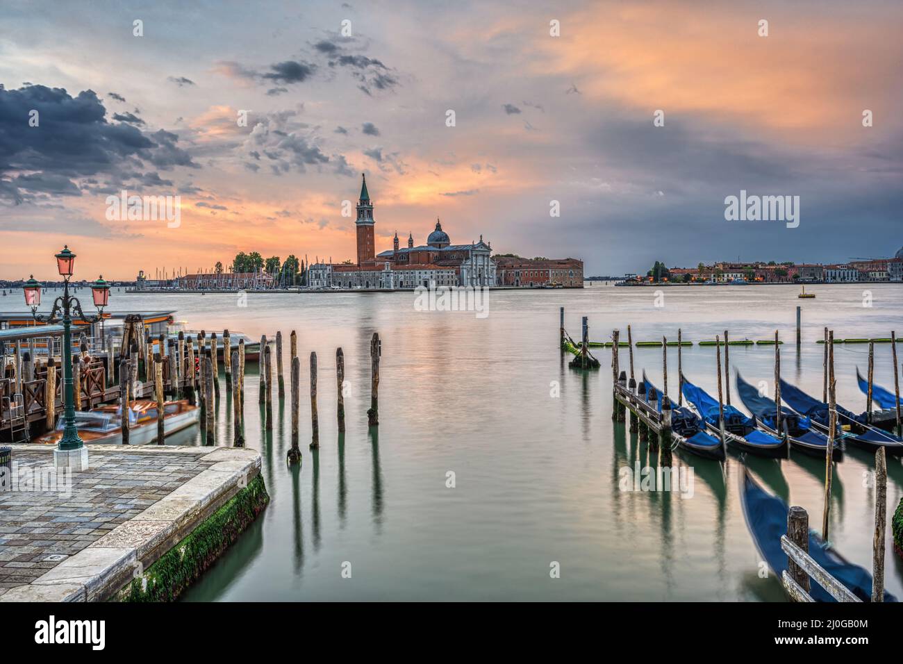 Dramatic sunrise in Venice, Italy, with some of the traditional gondolas Stock Photo