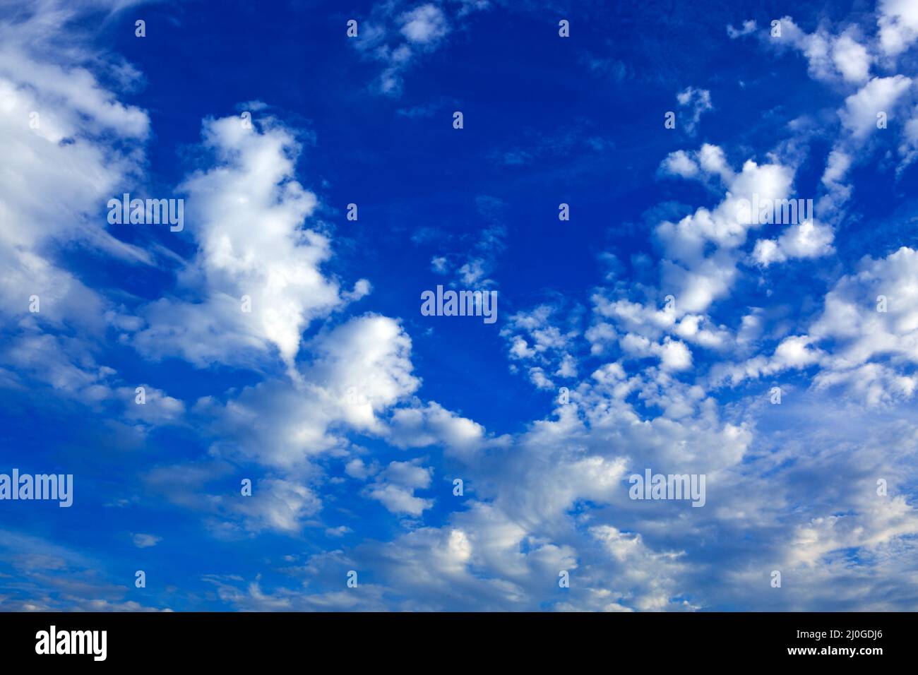 White fluffy clouds in the blue sky. Stock Photo
