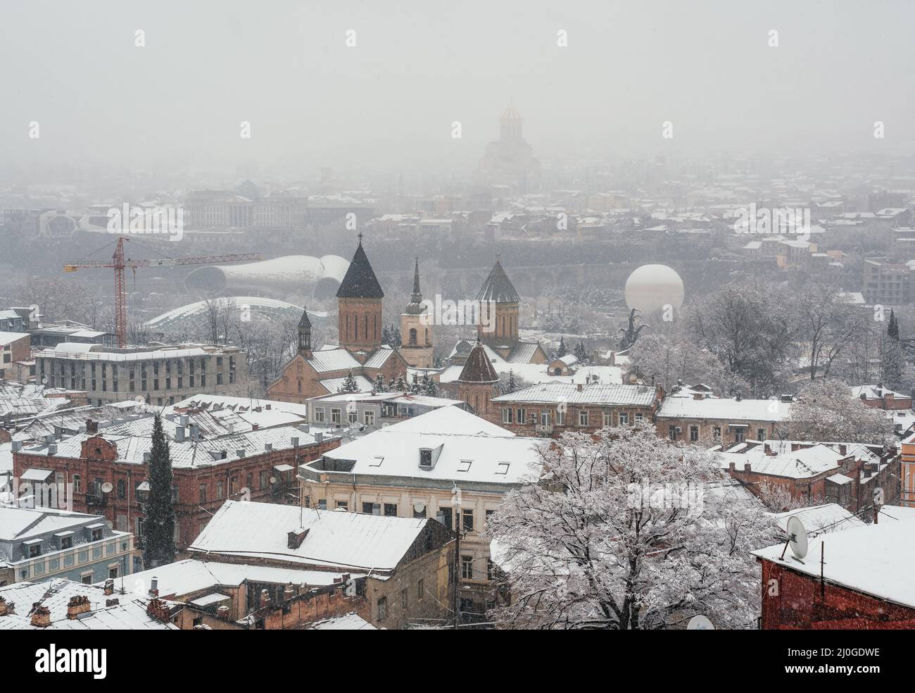 Tbilisi Old town covered with snow in misty day Stock Photo