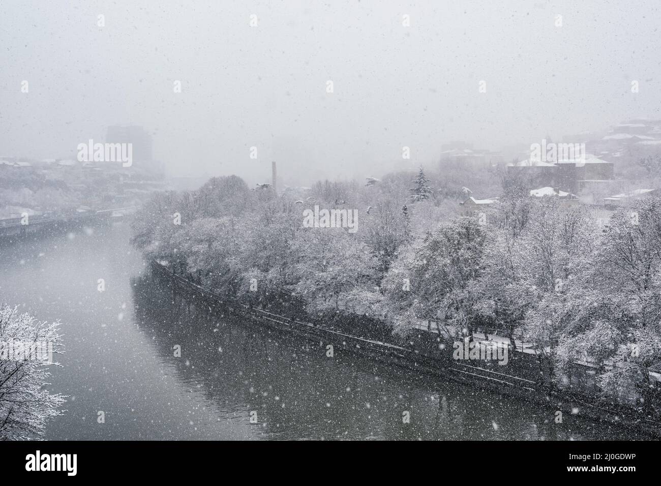 Kura river covered with snow in Tbilisi Stock Photo