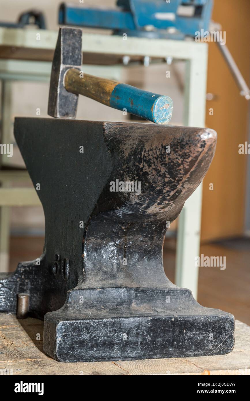 Hammer and anvil in a workshop - blacksmithing tool close-up Stock Photo
