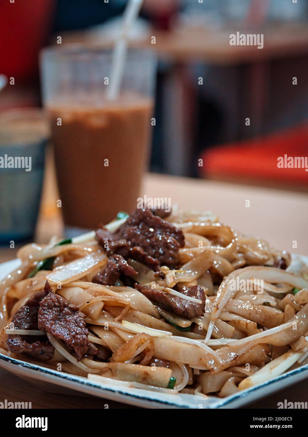 Closeup of Stirfried rice noodles with beef in a Cantonese restaurant
