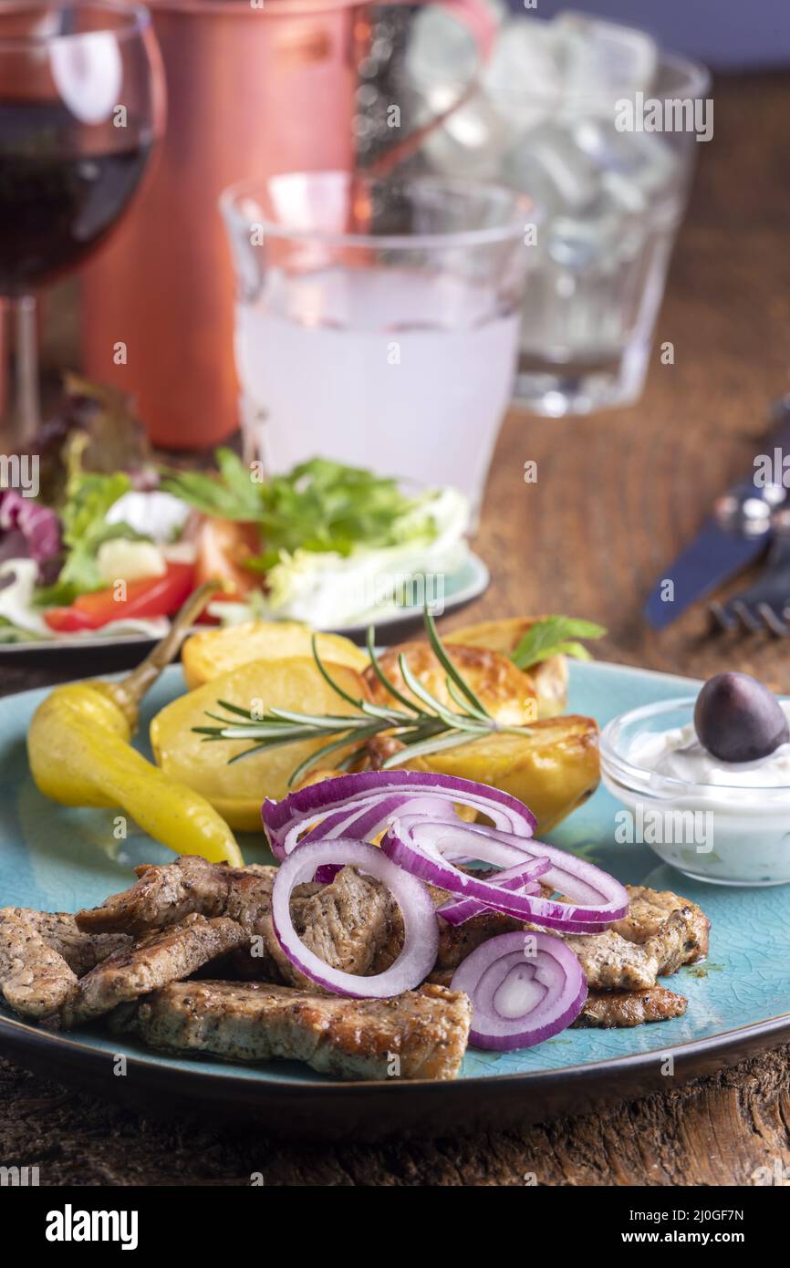 Greek gyros with salad and ouzo Stock Photo