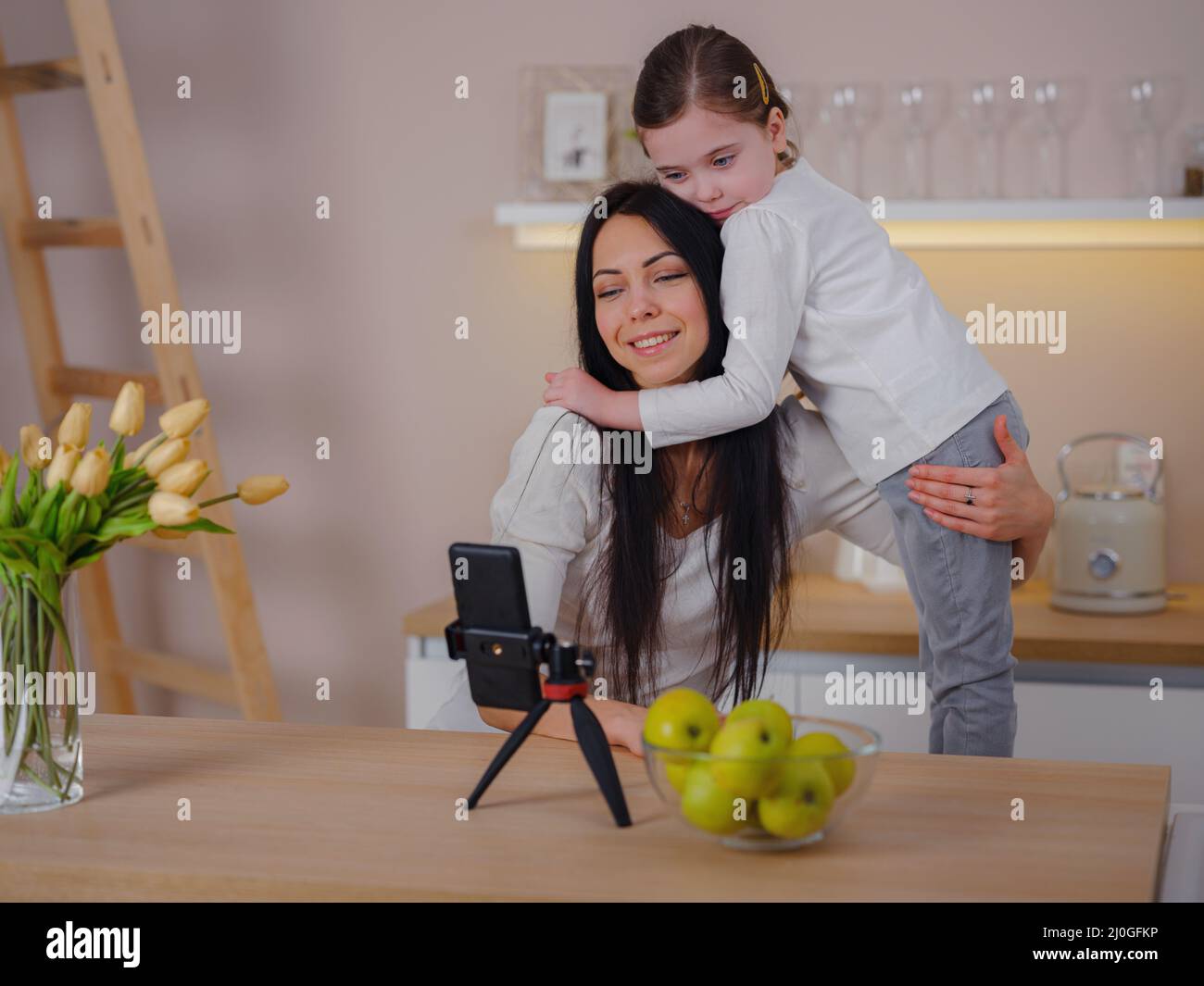 Blogger mom with her baby at home. Millennial Influencer woman creating ...