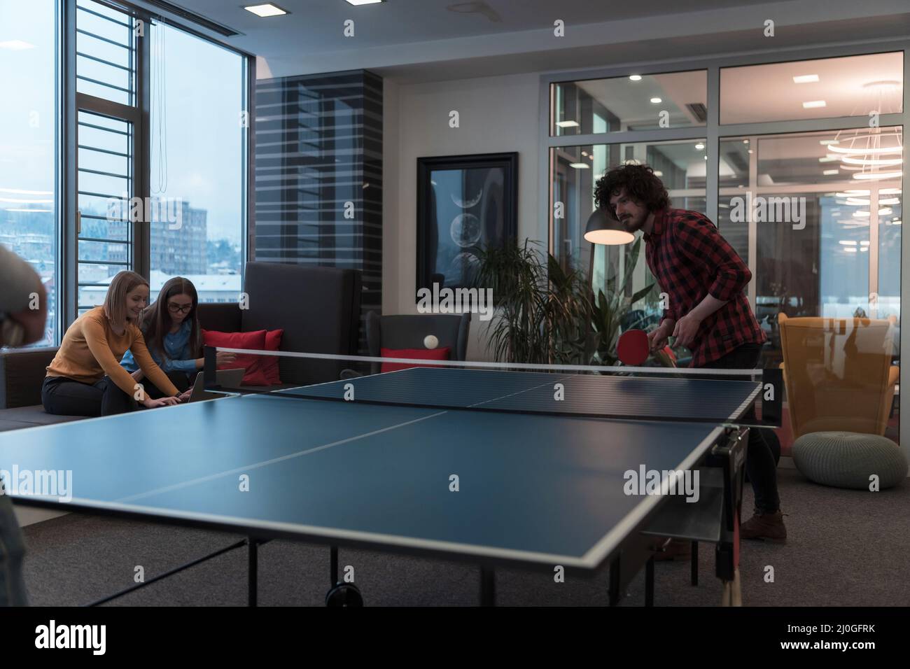 Two young start up business man playing ping pong tennis at modern creative  office space people group have meeting and brainstorming in background  Stock Photo - Alamy