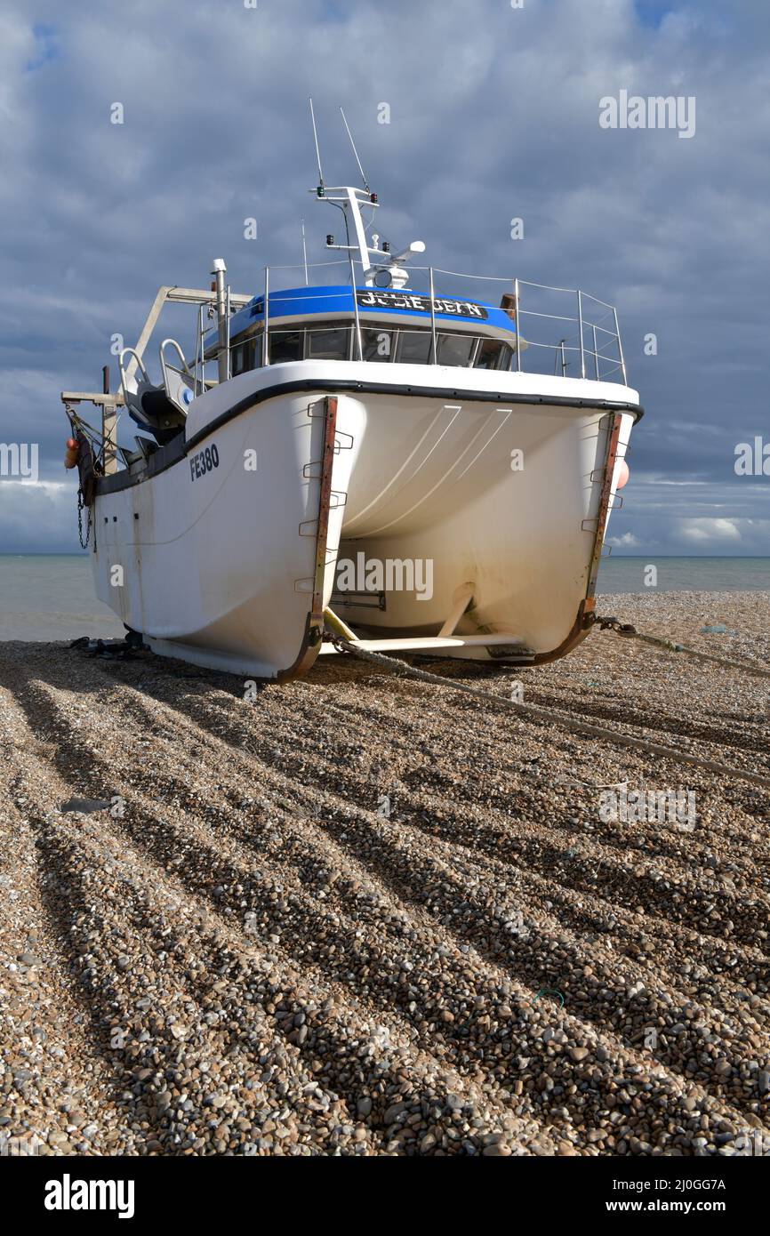 inshore fishing catamarran up on the beach at dungeness kent england Stock Photo