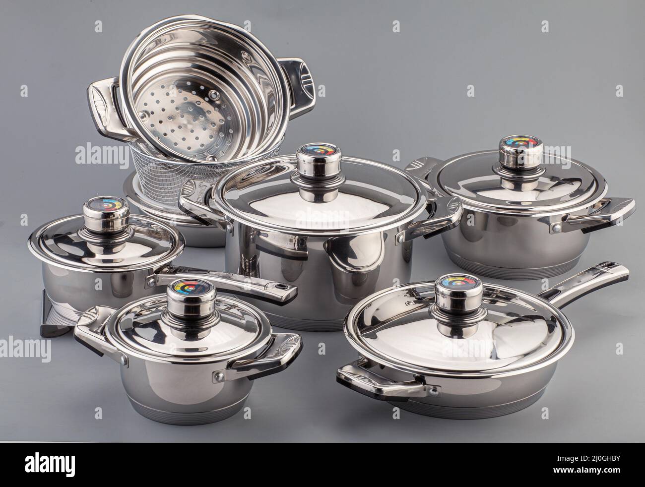 https://c8.alamy.com/comp/2J0GHBY/stainless-steel-cookware-pots-and-pans-on-gray-background-kitchenware-set-utensils-2J0GHBY.jpg
