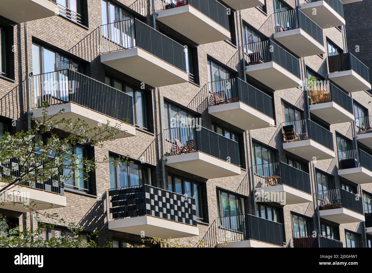 Detail of the facade of a modern apartment building with many balconies ...