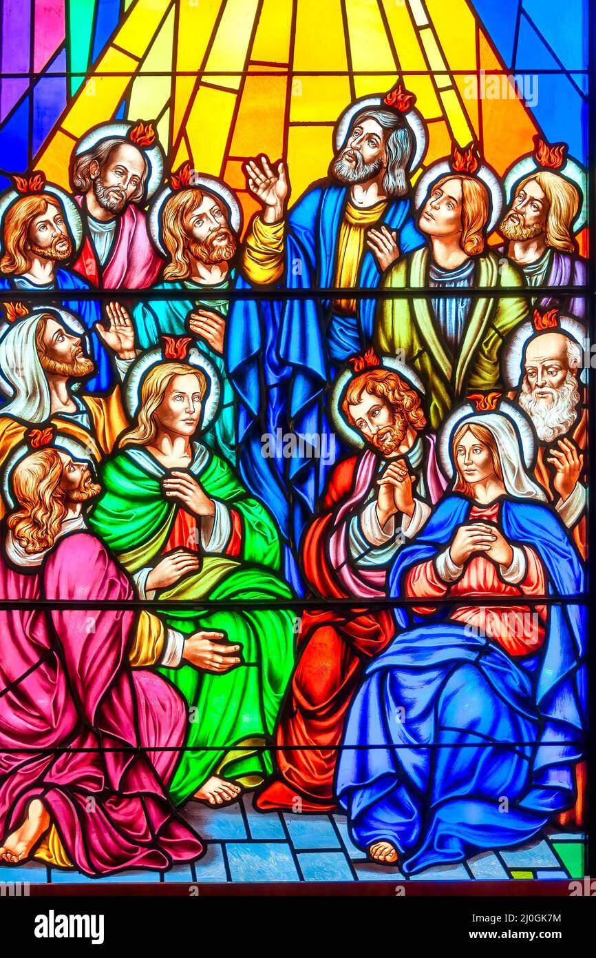 The advent of the Holy Spirit. Stained-glass window with Christian religious symbols seen in the Annunciation of the Blessed Virgin Mary Catholic Chur Stock Photo