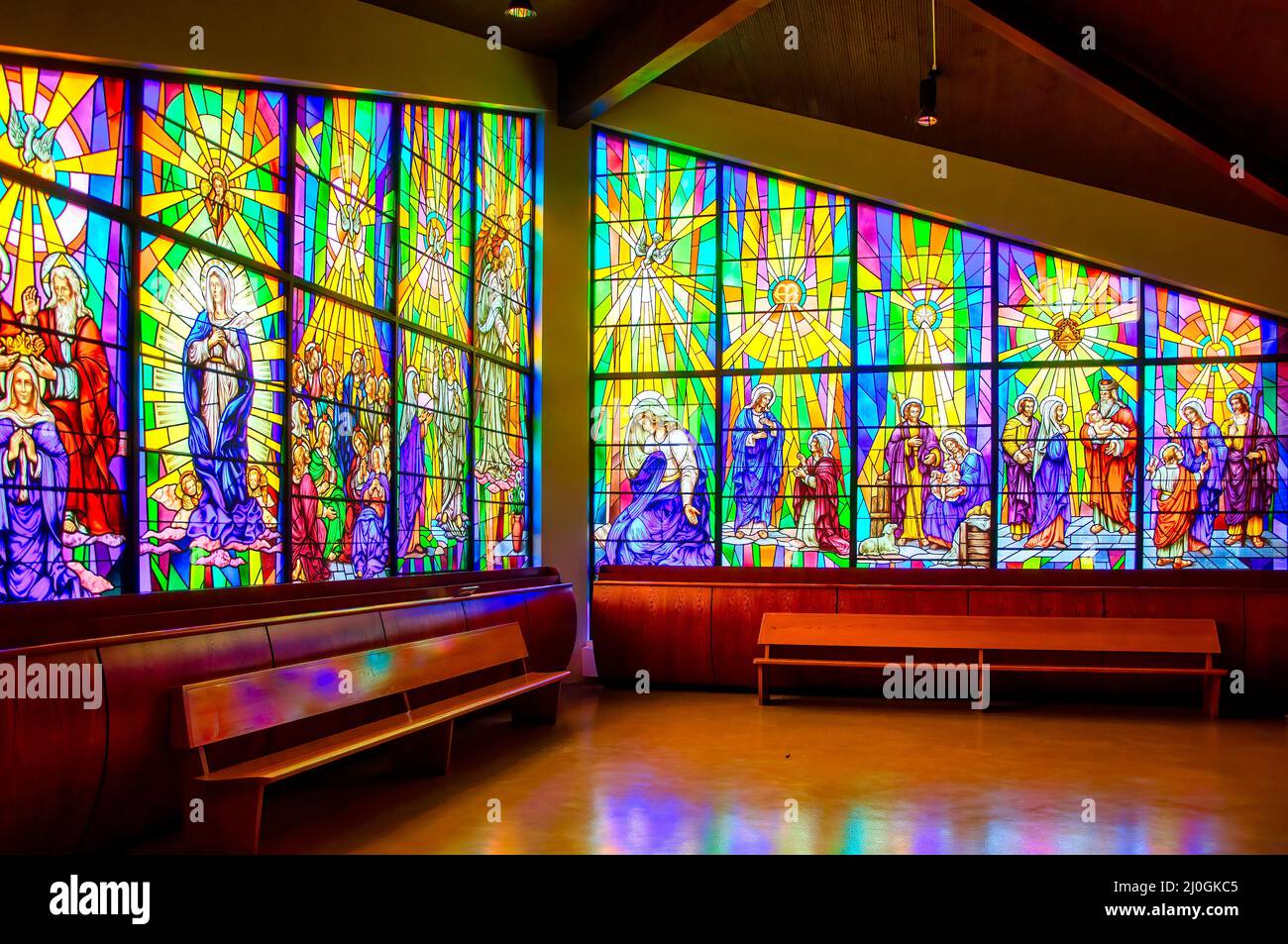 Whole view of a stained-glass window with Christian religious symbols seen in the Annunciation of the Blessed Virgin Mary Catholic Church Stock Photo