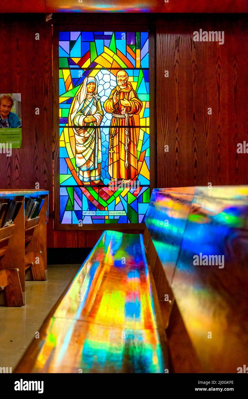 Gaetanella and Father stained-glass window with Christian religious symbols seen in the Annunciation of the Blessed Virgin Mary Catholic Church Stock Photo