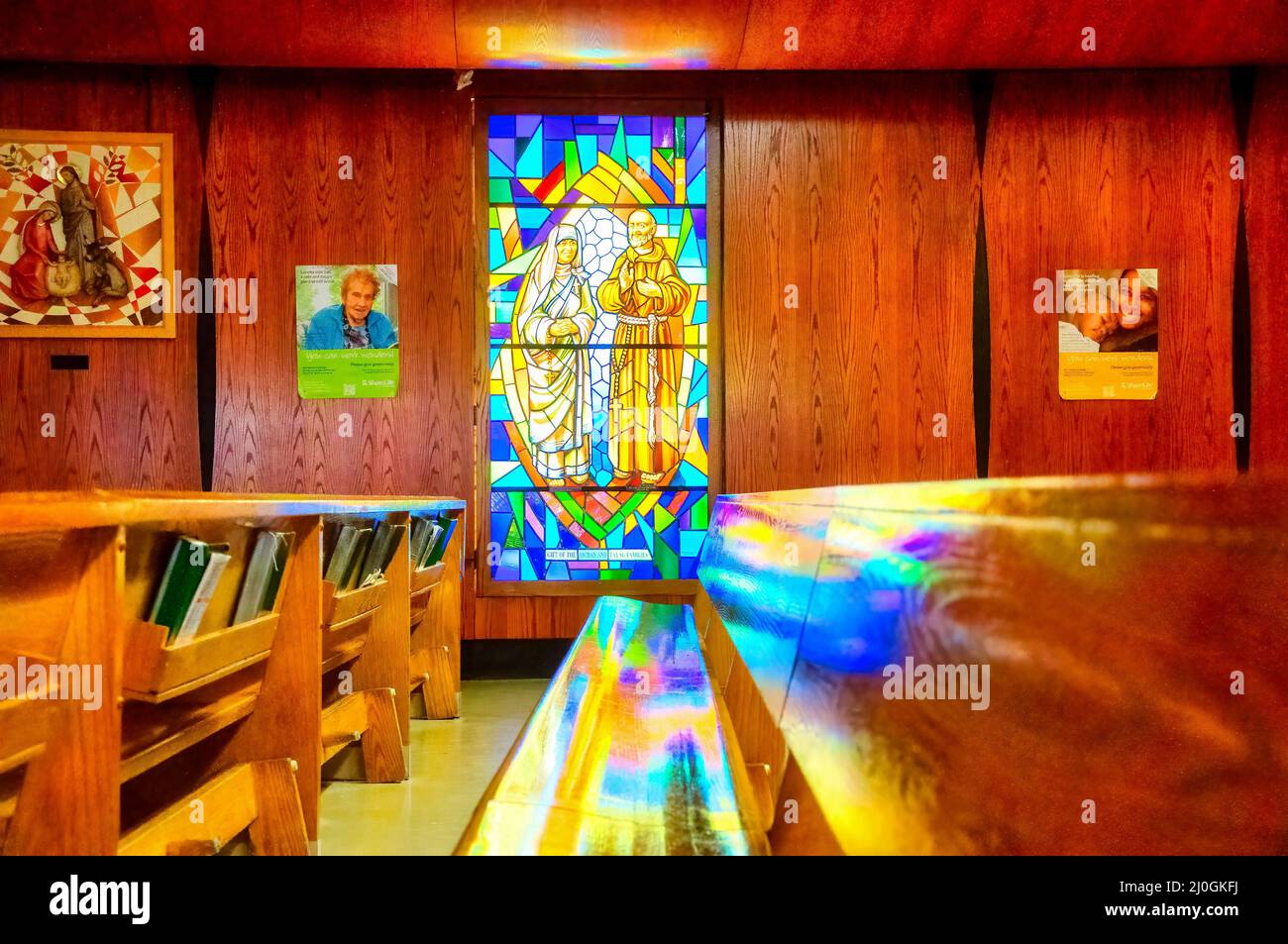 Stained-glass window with Christian religious symbols seen in the Annunciation of the Blessed Virgin Mary Catholic Church Stock Photo