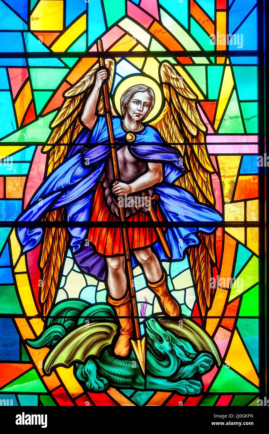 St. Michael the Archangel. Stained-glass window with Christian religious symbols seen in the Annunciation of the Blessed Virgin Mary Catholic Church Stock Photo