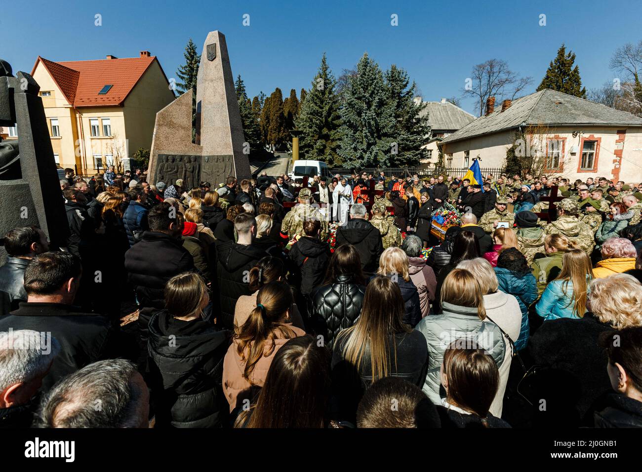 Uzhhorod, Ukraine. 19th Mar, 2022. People pay their last respects to three Ukrainian servicemen - staff sergeant Mykola Chyzh, commander of an engineering and sapper unit, sergeant Ihor Myronenko and officer Myroslav Diuryk - who perished in the fight against Russian invaders during the military funeral at the Hill of Glory, Uzhhorod, Zakarpattia Region, western Ukraine, on March 18, 2022. Photo by Serhii Hudak/Ukrinform/ABACAPRESS. Credit: Abaca Press/Alamy Live News Stock Photo