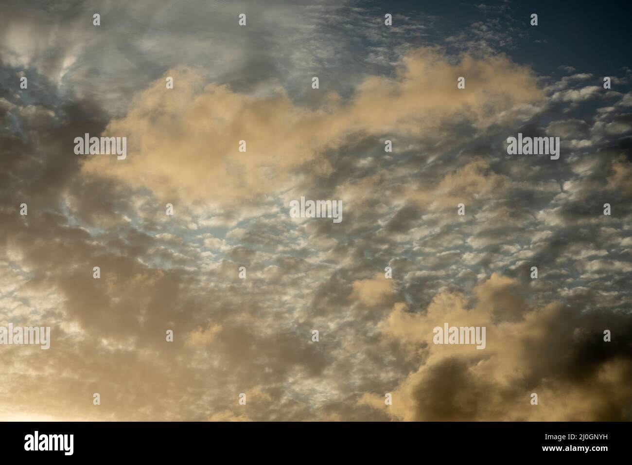 Beautiful orange colored clouds during sunset. Ceiling replacement tool. Stock Photo