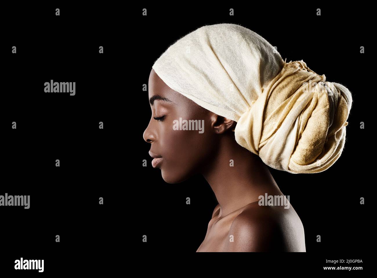 The profile of beauty. Studio shot of a beautiful woman wearing a headscarf against a black background. Stock Photo