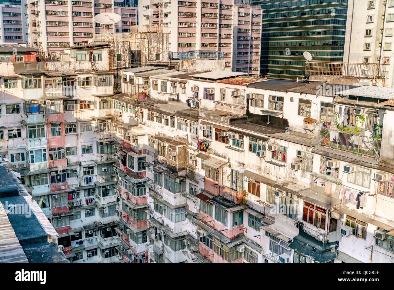 The popular between tourists place called Montane Mansion near to Tai Koo in Hong Kong. Overcrowded old retro building Stock Photo